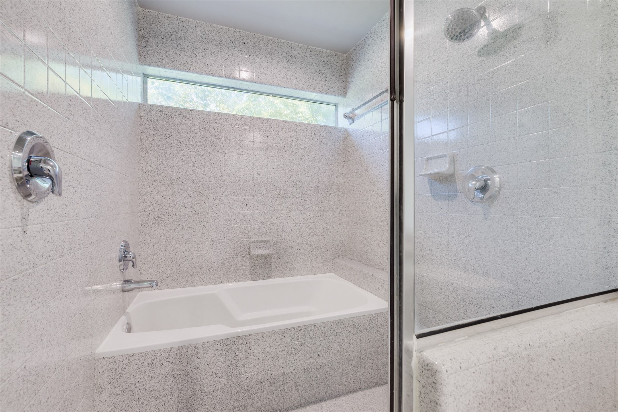 2605 Calumet Street, Unit 48 Houston, TX 77004 - Photo 32 of 34 a bathroom with a bathtub and a shower