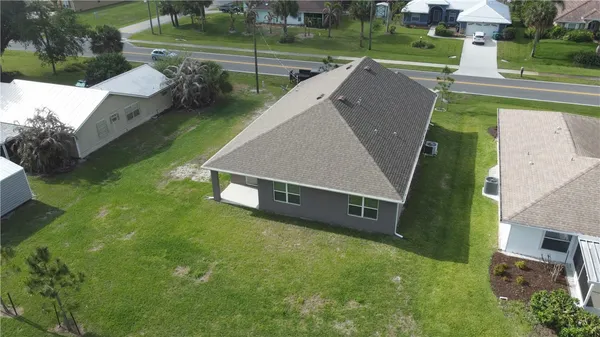 an aerial view of a house with a yard