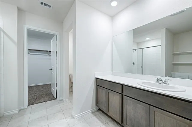 a bathroom with a shower and a glass door