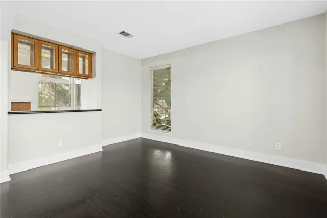 a view of a livingroom with furniture window and wooden floor