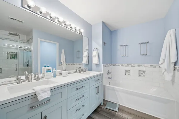 a bathroom with a bathtub and a shower