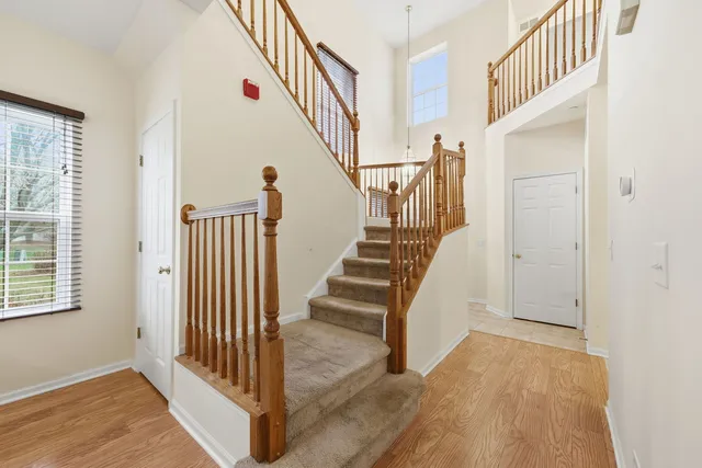 a view of a hallway with wooden floor and entryway