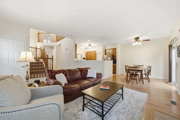 a living room with furniture a dining table and a piano table