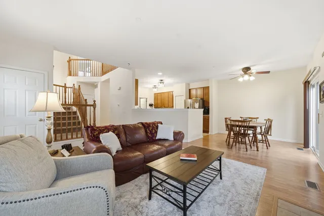 a living room with furniture a dining table and a piano table