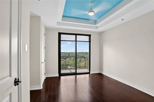 an empty room with wooden floor and a window