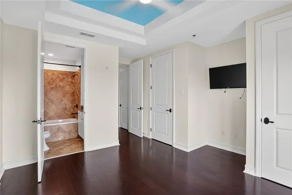 a bathroom with a granite countertop sink and a bathtub