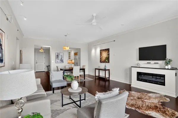 a living room with furniture a flat screen tv and a fireplace