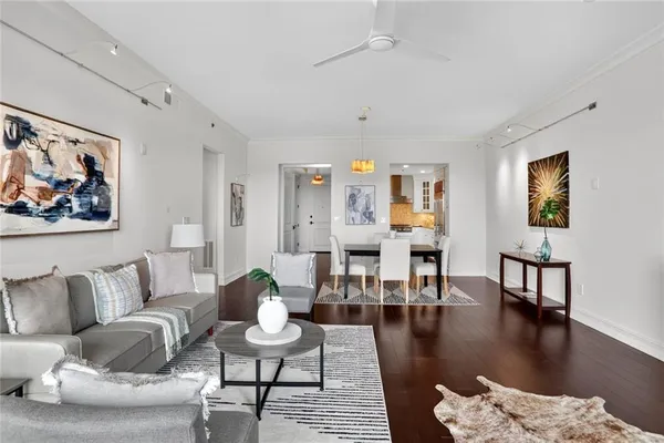 a living room with furniture and wooden floor