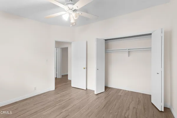 a view of an empty room with wooden floor