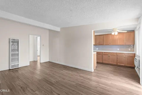 a view of a room with wooden floor and cabinet