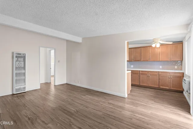 a view of a room with wooden floor and cabinet