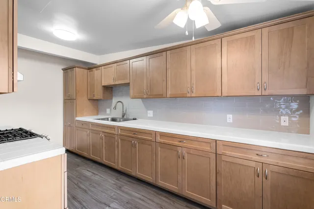 a kitchen with sink cabinets and window