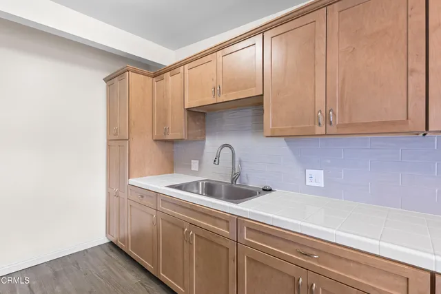 a kitchen with stainless steel appliances granite countertop a sink and a white cabinets