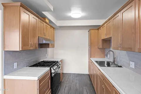 a kitchen that has a sink and a stove in it