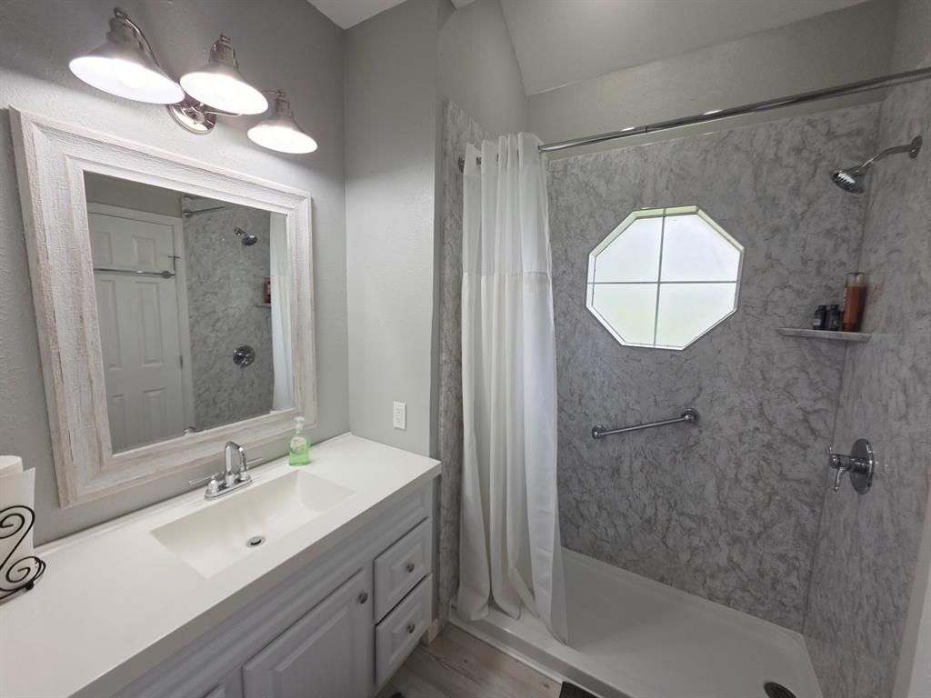 520 Red River Road Belton, TX 76513 - Photo 16 of 36 Full bathroom featuring a walk-in shower with a patterned surround and an octagonal window