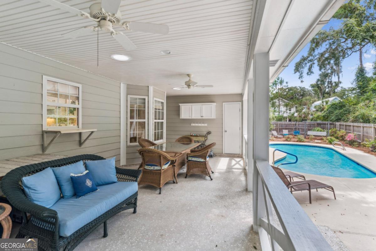 311 Dunbarton Drive St. Simons, GA 31522 - Photo 12 of 44 a living room with furniture and a large window