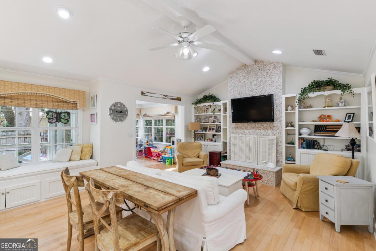 311 Dunbarton Drive St. Simons, GA 31522 - Photo 16 of 44 a living room with furniture and a flat screen tv