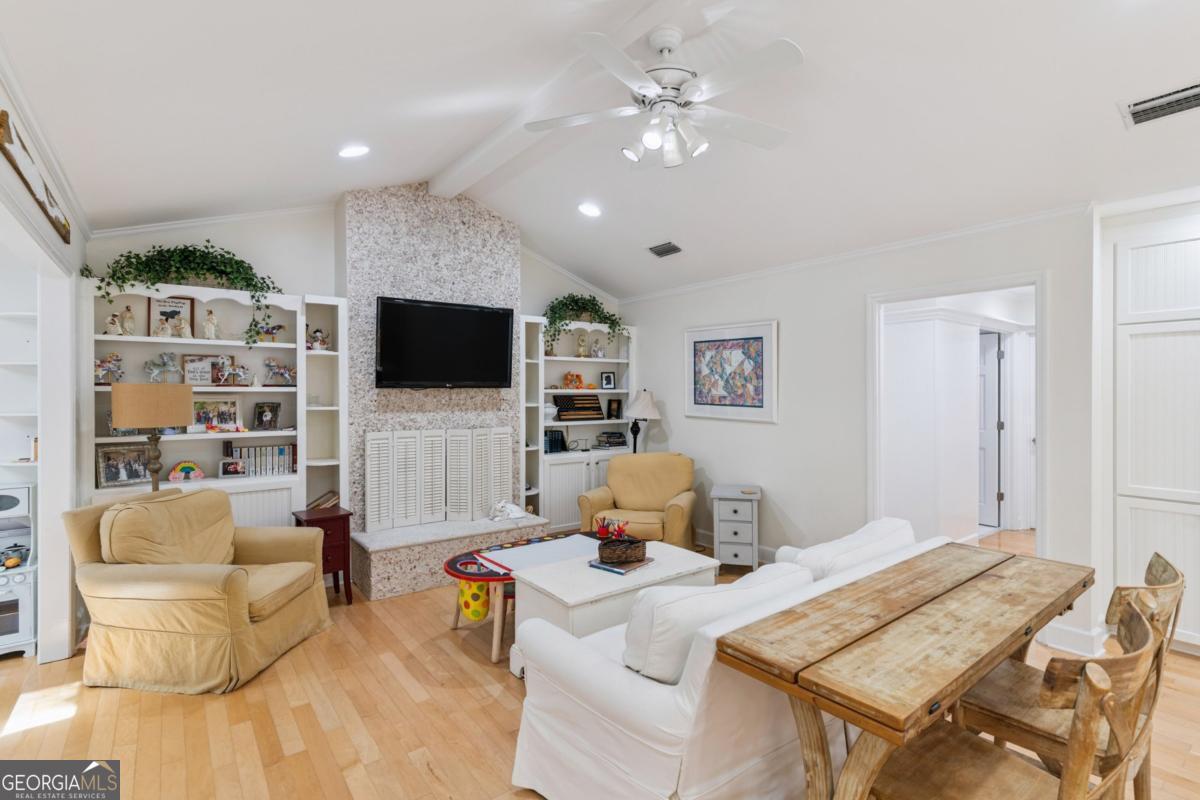311 Dunbarton Drive St. Simons, GA 31522 - Photo 17 of 44 a living room with furniture and a flat screen tv