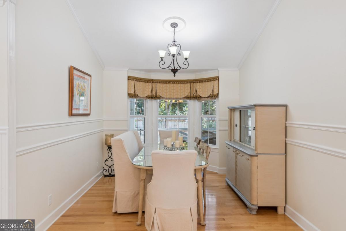 311 Dunbarton Drive St. Simons, GA 31522 - Photo 20 of 44 a view of a dining room with furniture window and wooden floor
