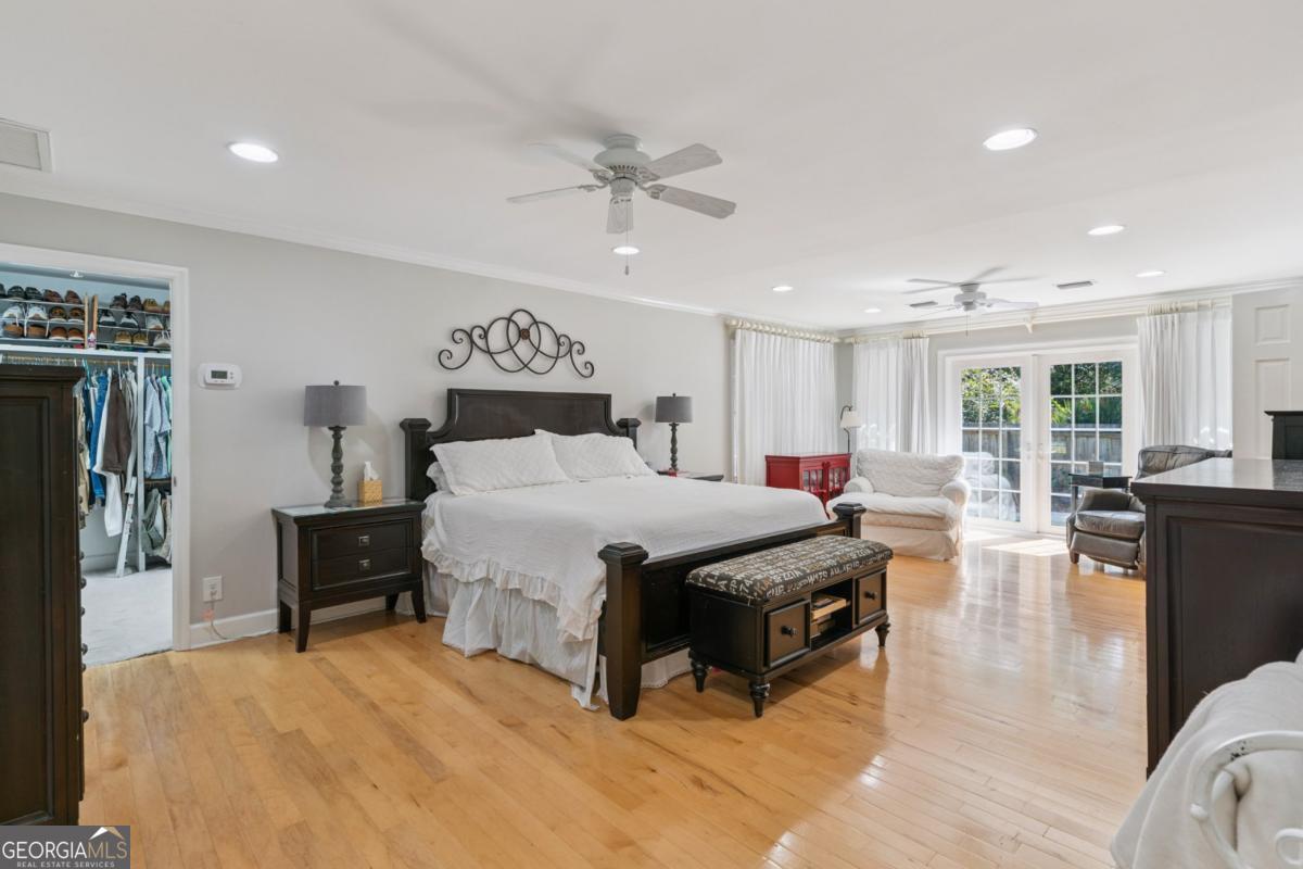 311 Dunbarton Drive St. Simons, GA 31522 - Photo 24 of 44 a bedroom with a bed and wooden floor