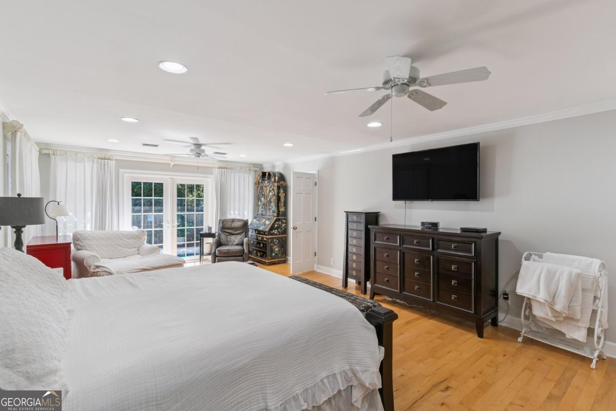 311 Dunbarton Drive St. Simons, GA 31522 - Photo 25 of 44 a bedroom with a bed and a flat screen tv