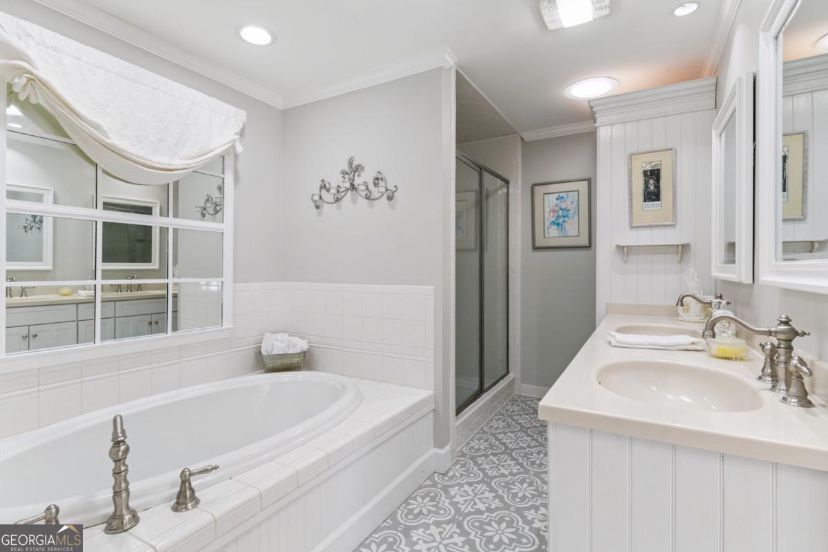 311 Dunbarton Drive St. Simons, GA 31522 - Photo 26 of 44 a bathroom with a tub sink and mirror