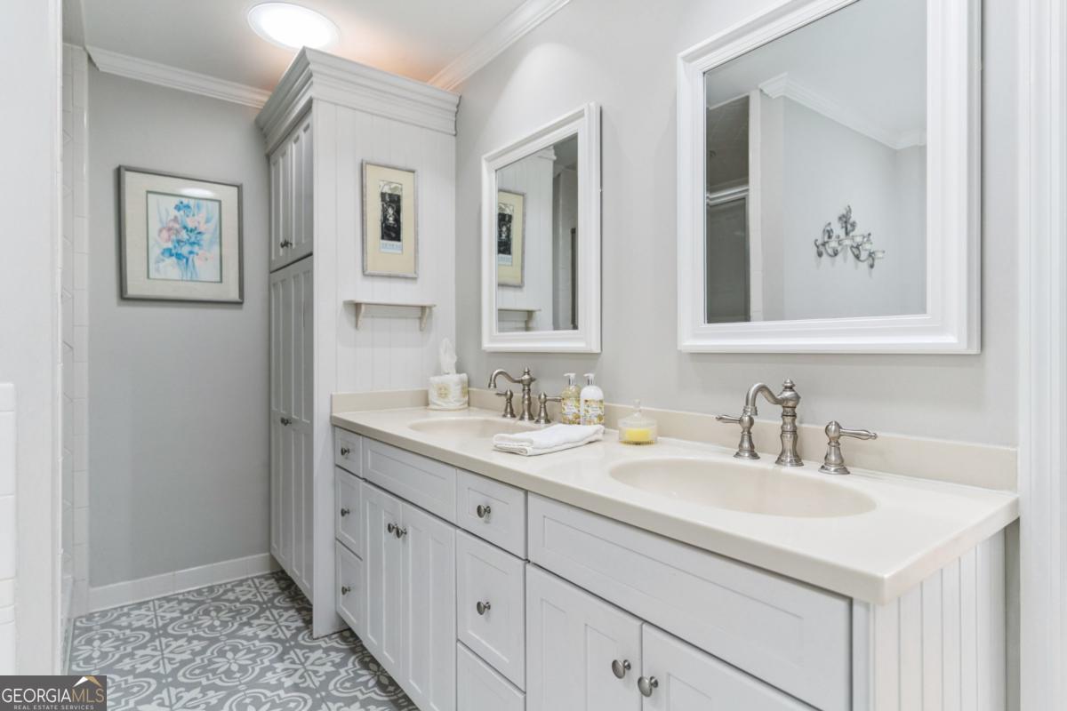 311 Dunbarton Drive St. Simons, GA 31522 - Photo 27 of 44 a bathroom with double sink and a mirror