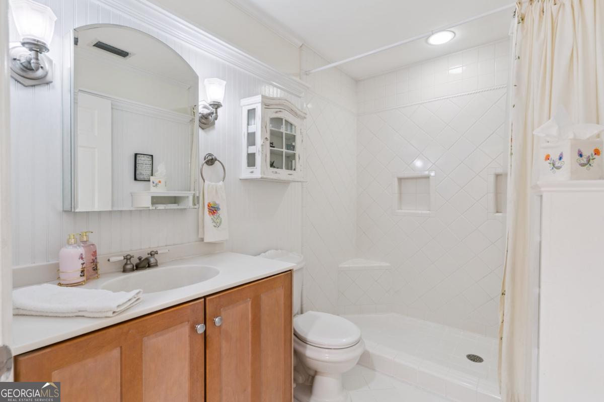 311 Dunbarton Drive St. Simons, GA 31522 - Photo 34 of 44 a bathroom with a sink a toilet and shower