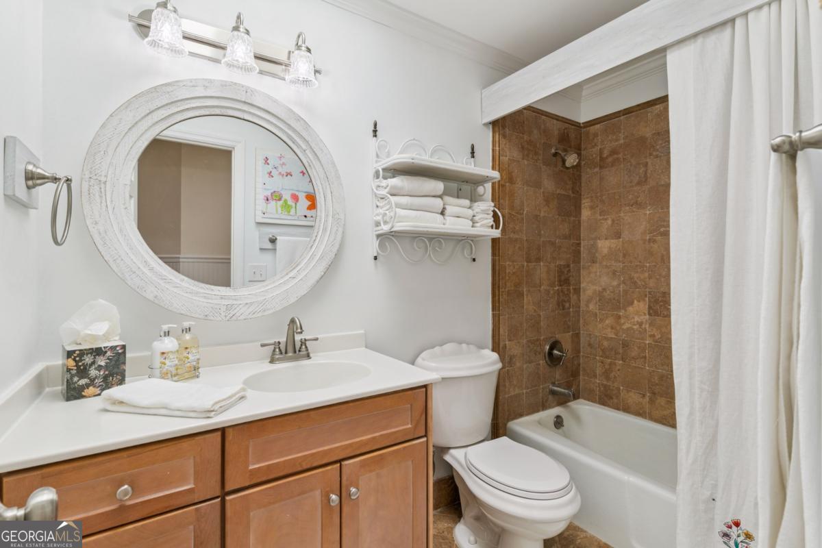 311 Dunbarton Drive St. Simons, GA 31522 - Photo 35 of 44 a bathroom with a sink a toilet and a mirror