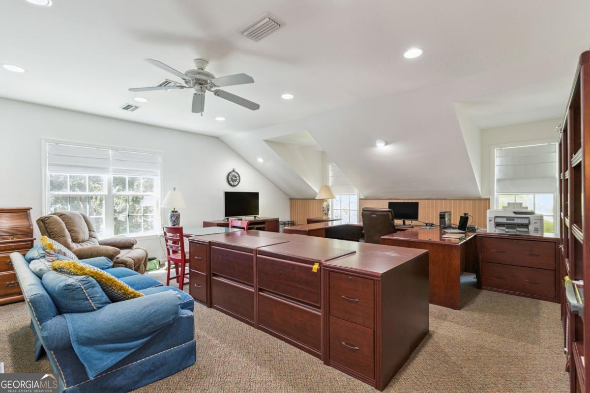 311 Dunbarton Drive St. Simons, GA 31522 - Photo 40 of 44 a kitchen with stainless steel appliances kitchen island granite countertop a sink and cabinets