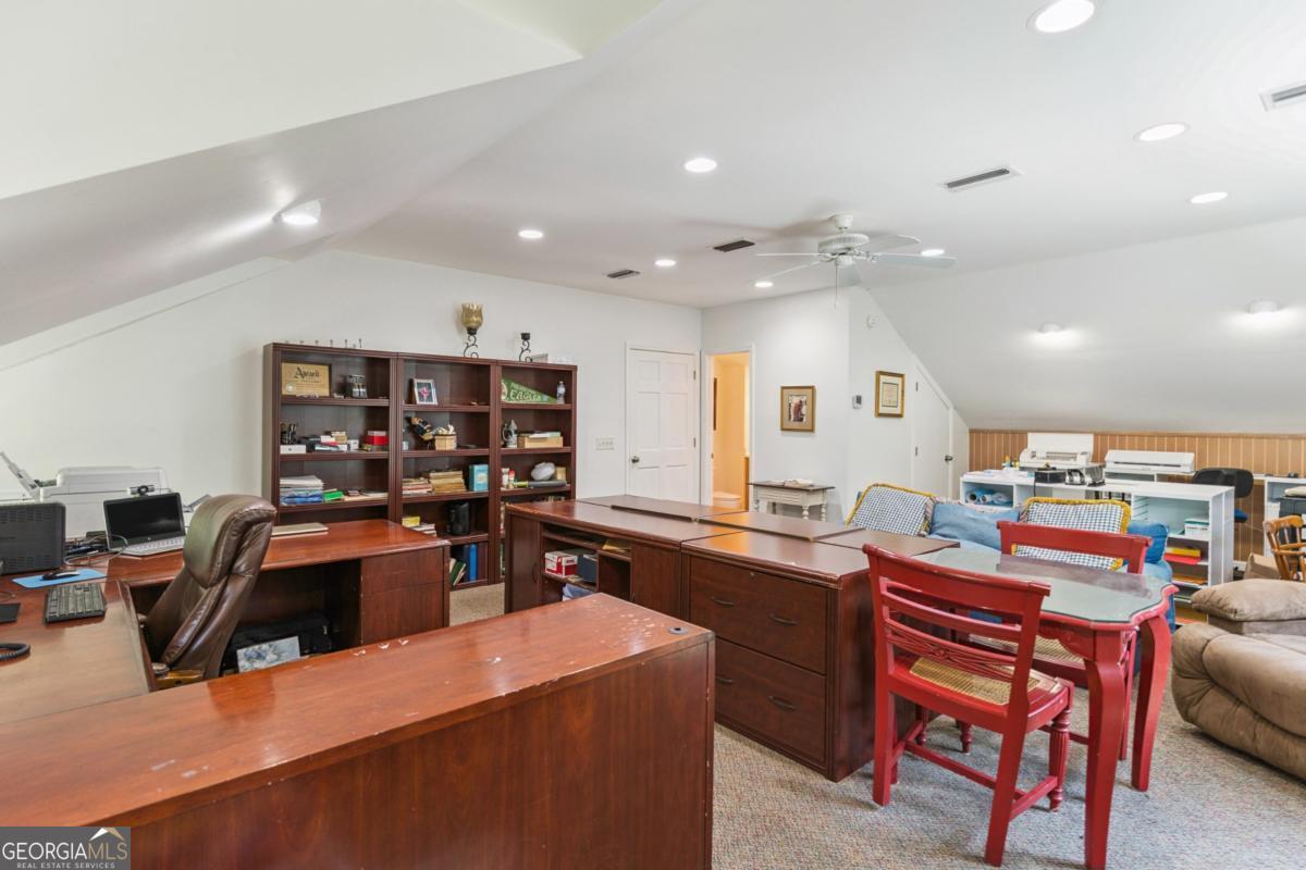 311 Dunbarton Drive St. Simons, GA 31522 - Photo 42 of 44 a kitchen and a a dining table in a room