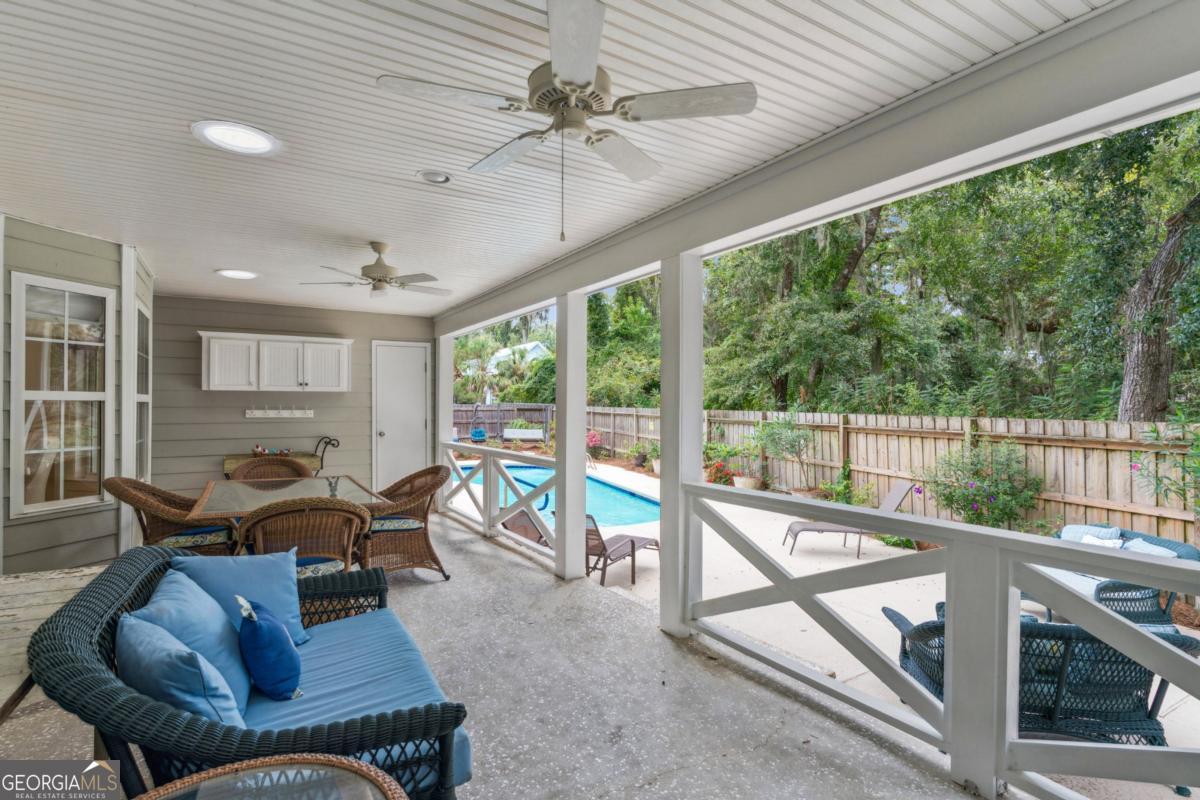 311 Dunbarton Drive St. Simons, GA 31522 - Photo 9 of 44 a living room with furniture tv and a large window