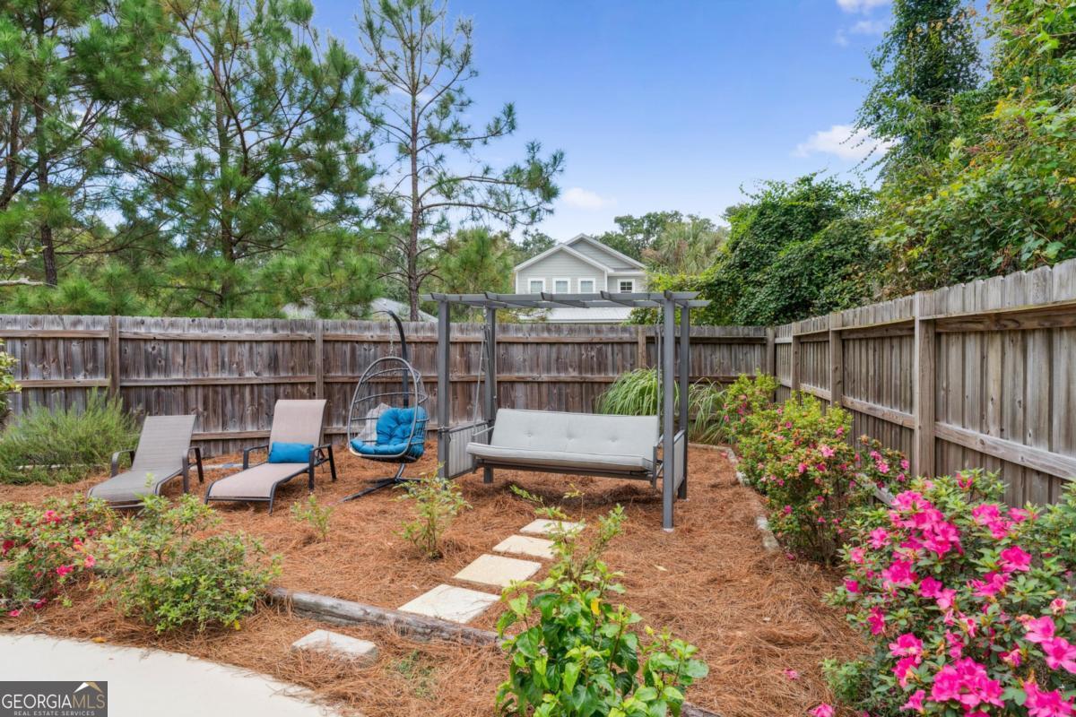 311 Dunbarton Drive St. Simons, GA 31522 - Photo 10 of 44 a view of a backyard with sitting area and furniture