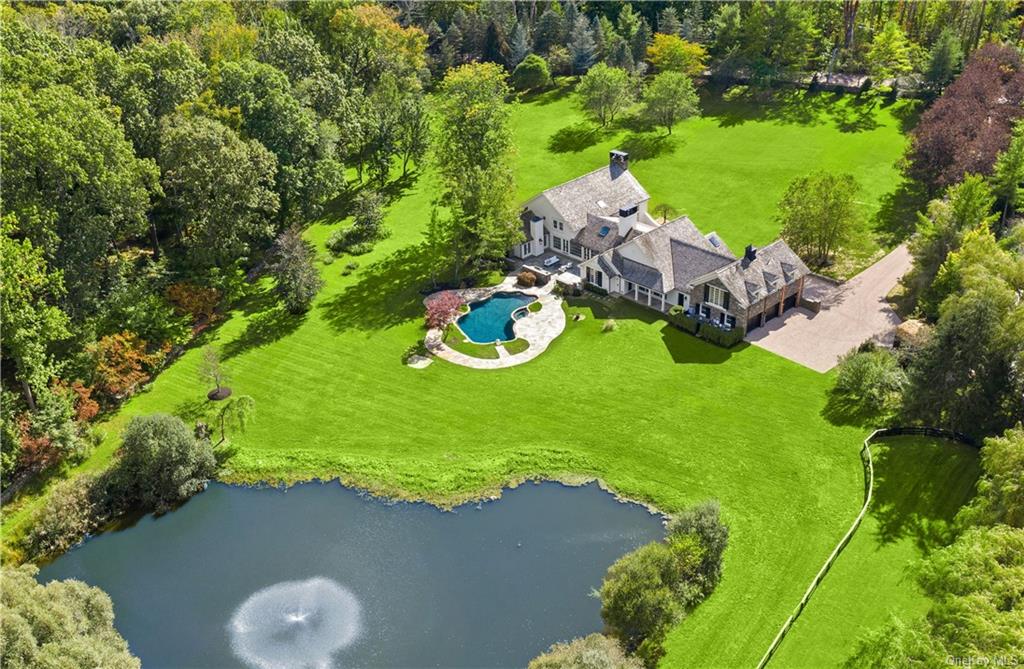 a aerial view of a house with yard swimming pool and outdoor seating