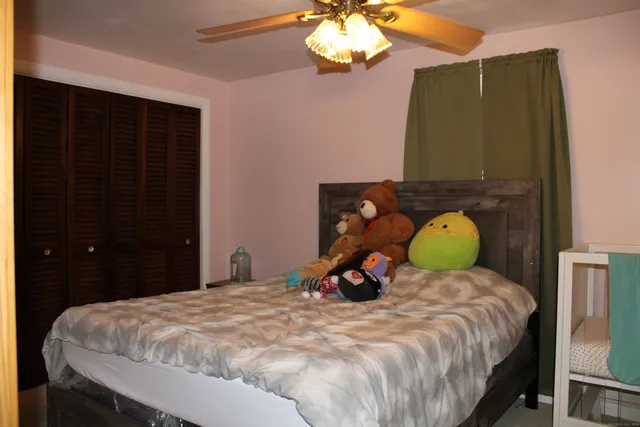 a bedroom with a bed and a chandelier