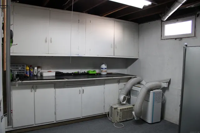 a kitchen with a sink a cabinets and appliances