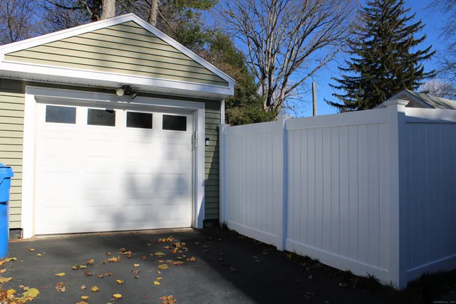 a view of backyard with a large tree