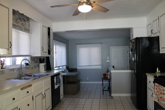 a kitchen that has a refrigerator and a sink
