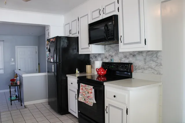 a kitchen with stainless steel appliances a refrigerator stove and microwave