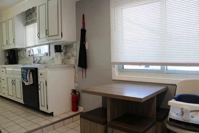 a kitchen with a sink cabinets and appliances