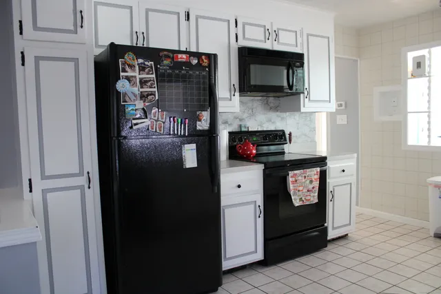 a kitchen with stainless steel appliances a refrigerator and a stove top oven