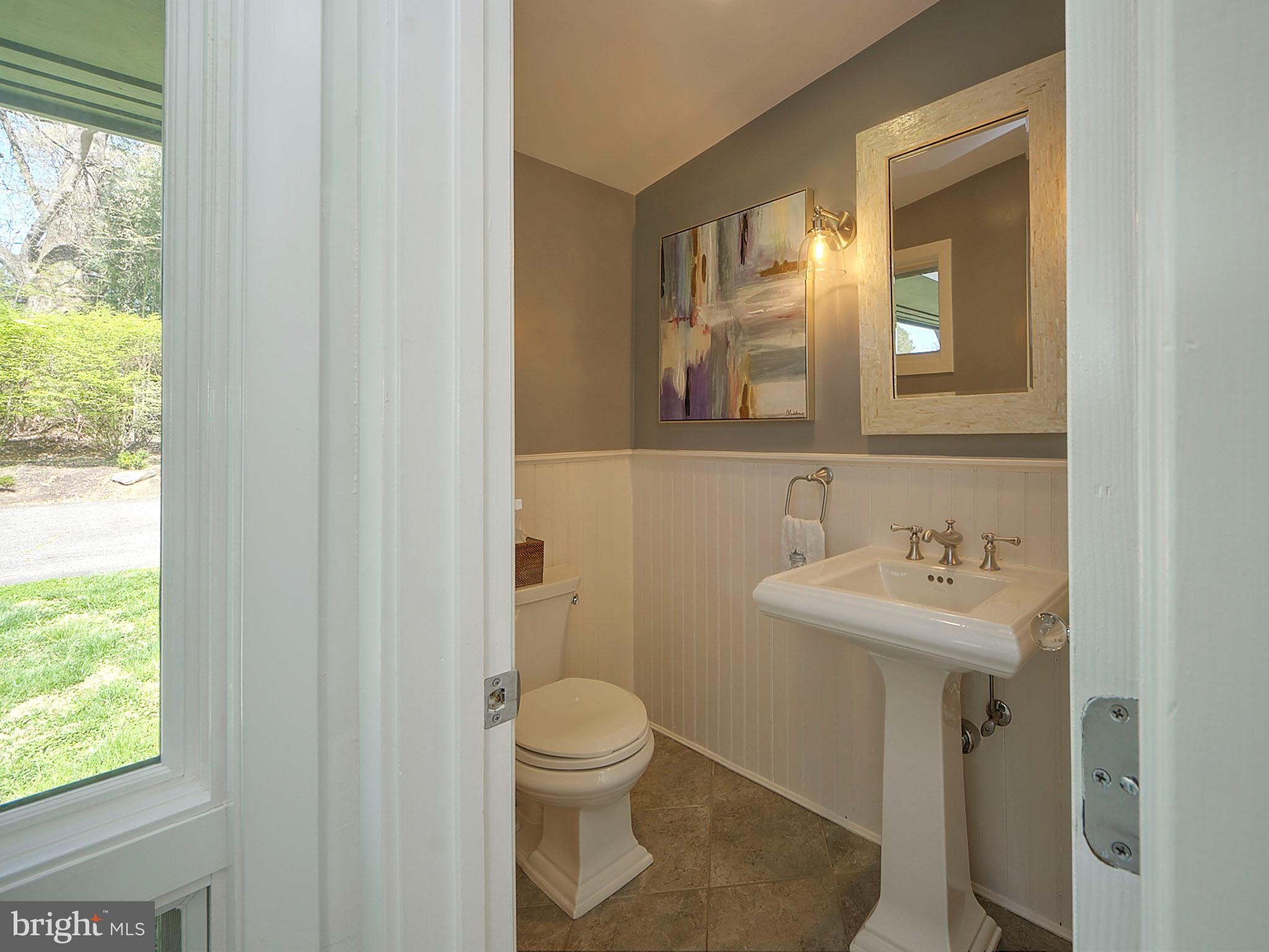 112 South Spring Valley Road Wilmington, DE 19807 - Photo 19 of 37 a bathroom with a sink toilet and a mirror