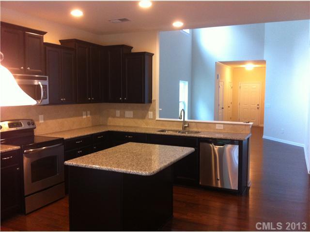 78050 Rillstone Drive Lancaster, SC 29720 - Photo 5 of 14 a kitchen with a sink a microwave a stove and cabinets