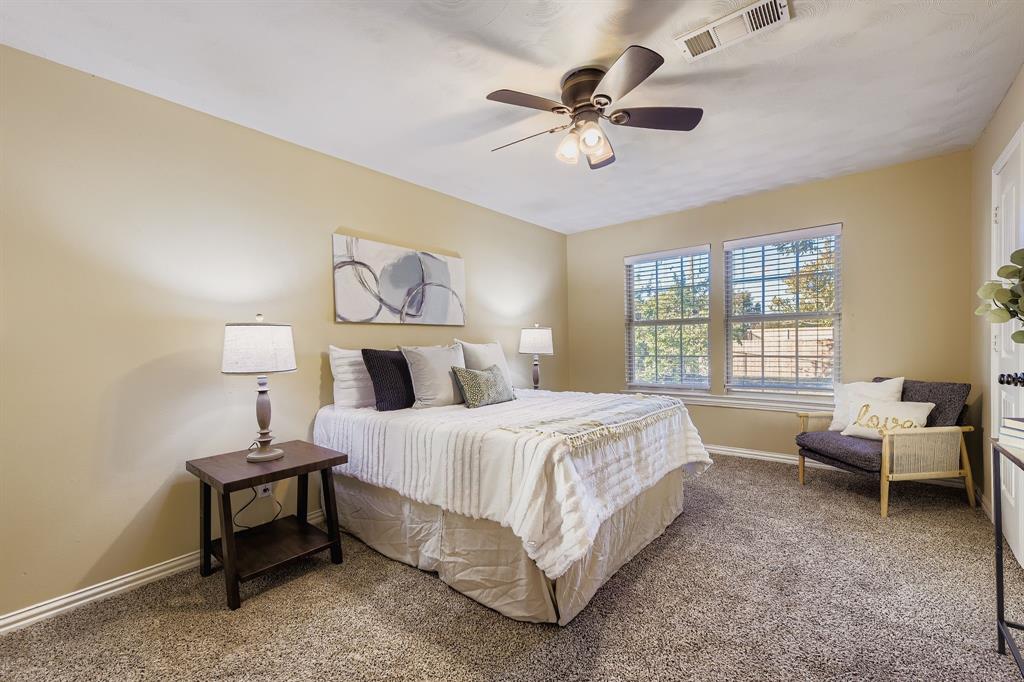 2801 Fairbrook Street Irving, TX 75062 - Photo 13 of 23 a bedroom with a bed and a chandelier