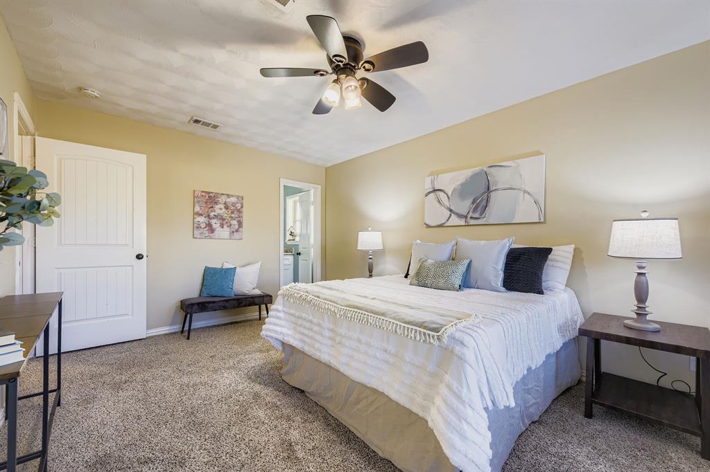 2801 Fairbrook Street Irving, TX 75062 - Photo 14 of 23 a bedroom with a bed and a table in it