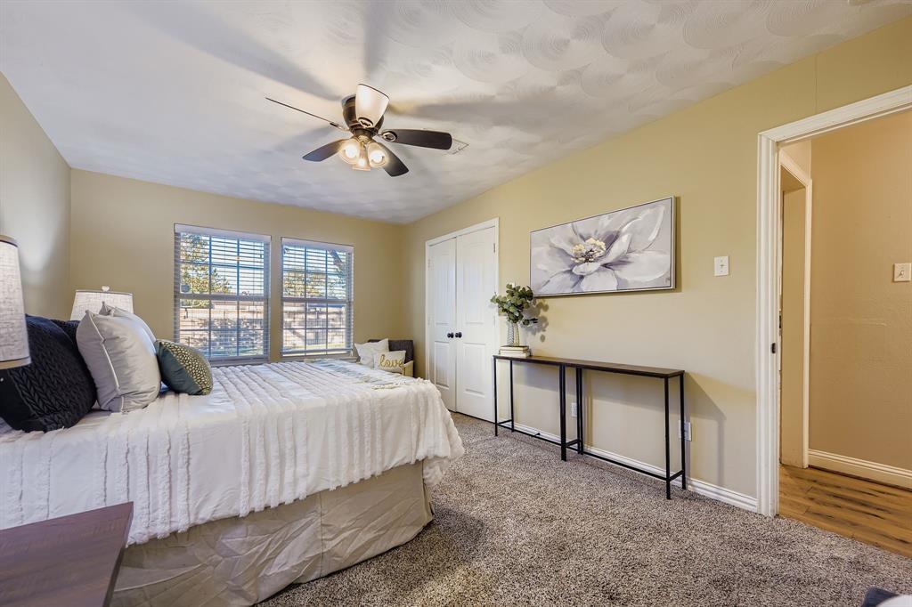 2801 Fairbrook Street Irving, TX 75062 - Photo 15 of 23 a bedroom with a bed a table and painting on the wall