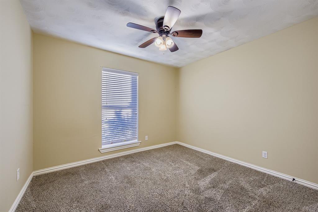 2801 Fairbrook Street Irving, TX 75062 - Photo 18 of 23 an empty room with a ceiling fan and window