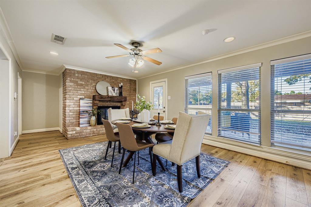 2801 Fairbrook Street Irving, TX 75062 - Photo 7 of 23 a dining room with furniture a chandelier and wooden floor