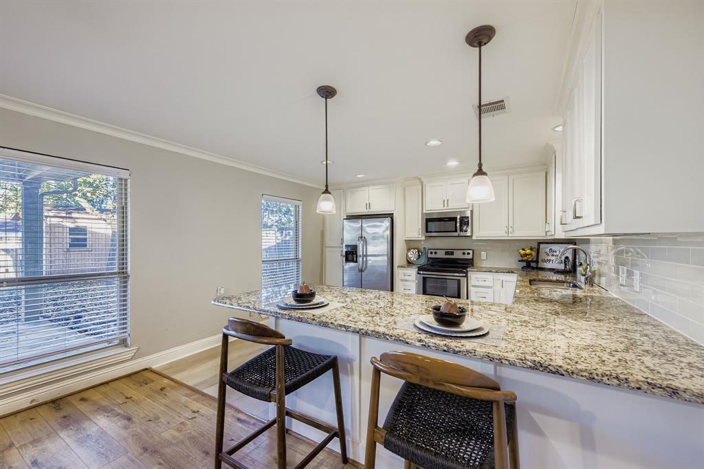 2801 Fairbrook Street Irving, TX 75062 - Photo 8 of 23 a kitchen with stainless steel appliances granite countertop a sink a stove and chairs