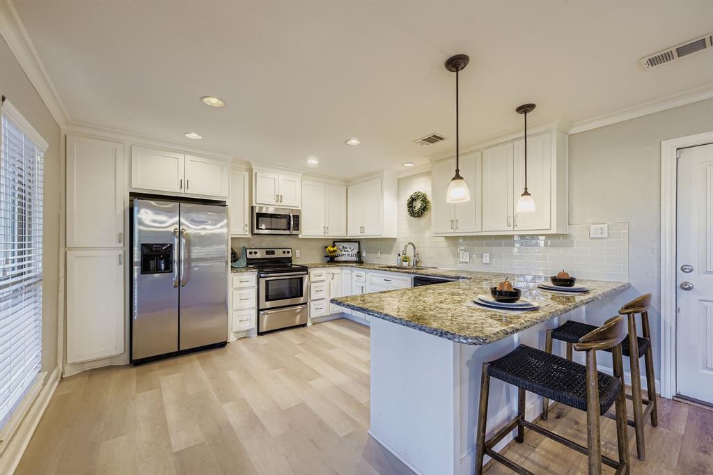 2801 Fairbrook Street Irving, TX 75062 - Photo 9 of 23 a kitchen with a center island appliances and cabinets